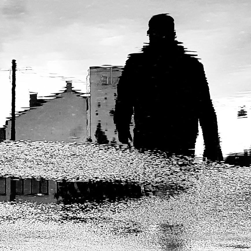 man walking black and white photo blurry