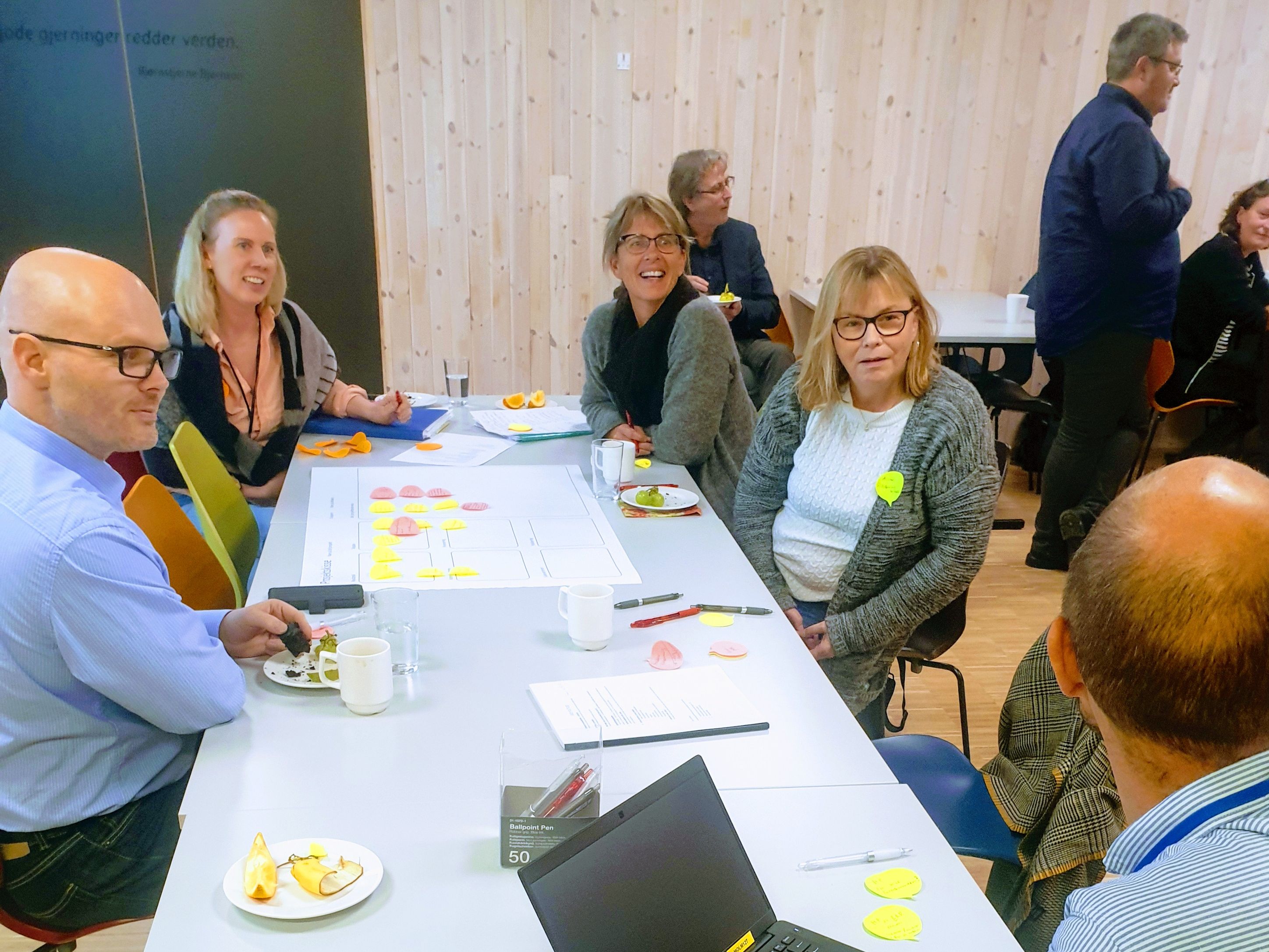people aoround a table discussing in a workshop