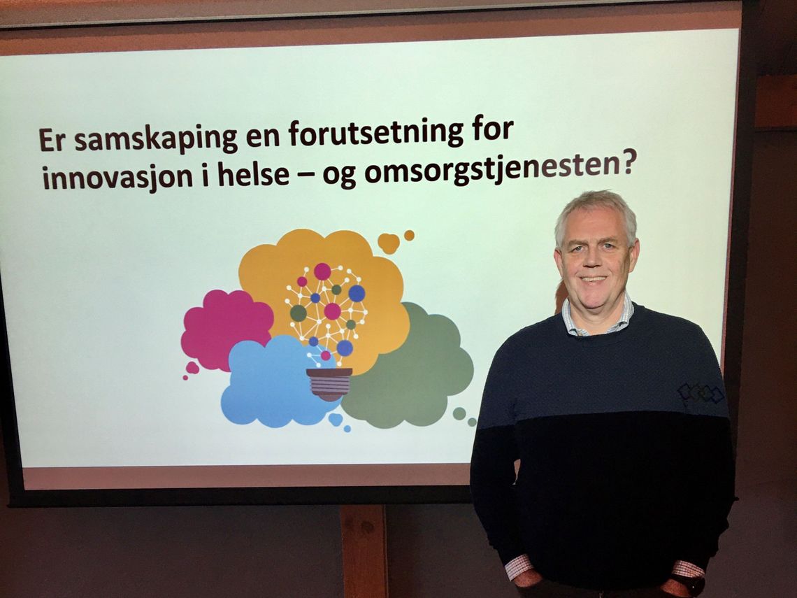 man in front of powerpoint on cocreation