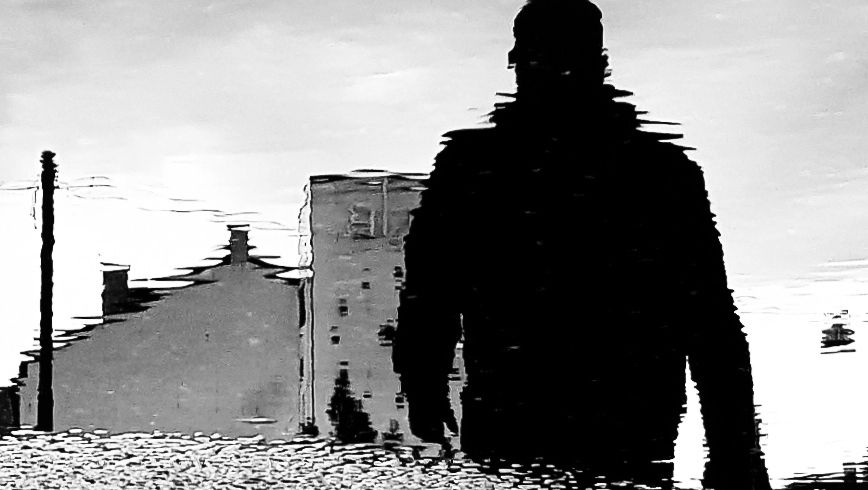 man walking black and white photo blurry